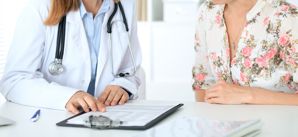 A women consulting a doctor.