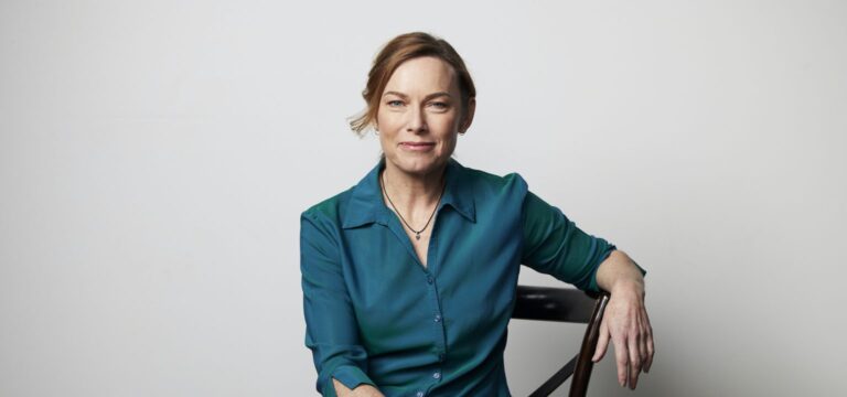 Professional woman seated confidently against a neutral background, representing leadership behind WellFemme’s Senate Inquiry submission on menopause care.