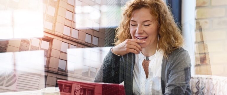 Smiling woman using a laptop at home, representing accessible and supportive online menopause care from WellFemme