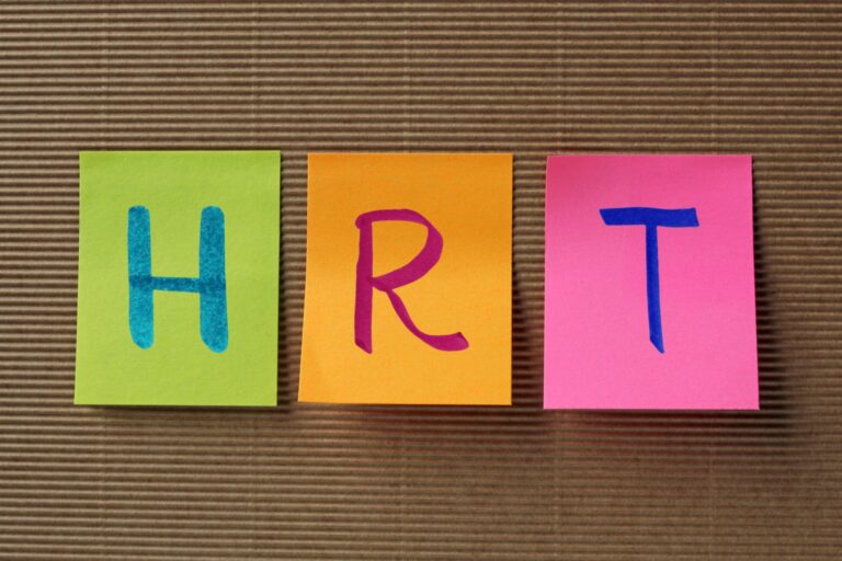 Colourful sticky notes spelling “HRT”, promoting a live-streamed hormone replacement therapy workshop.